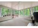 Enclosed sunroom with wooded views and a sliding glass door to the exterior deck at 3573 Bramwell Nw Xing, Kennesaw, GA 30144