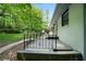 Home's patio with iron railing that overlooks the spacious, grassy backyard at 3904 Bakers Ferry Sw Rd, Atlanta, GA 30331