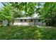 Spacious backyard with a patio, lush green grass, and mature trees at 3904 Bakers Ferry Sw Rd, Atlanta, GA 30331