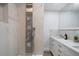 Modern bathroom featuring a multi-jet shower system, marble countertops, and white cabinets at 3904 Bakers Ferry Sw Rd, Atlanta, GA 30331