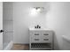Elegant bathroom with modern vanity, stylish lighting fixture, and wood-look flooring at 3904 Bakers Ferry Sw Rd, Atlanta, GA 30331
