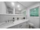 Bright bathroom with double sink vanity, quartz countertop, a large mirror and natural light at 3904 Bakers Ferry Sw Rd, Atlanta, GA 30331