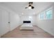 Light filled bedroom with a ceiling fan, light wood-look floors and white walls at 3904 Bakers Ferry Sw Rd, Atlanta, GA 30331