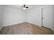 Simple bedroom featuring light wood-look floors, white walls, and a ceiling fan at 3904 Bakers Ferry Sw Rd, Atlanta, GA 30331