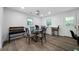 Bright dining area with a glass table, unique seating, and light wood floors offers a welcoming space at 3904 Bakers Ferry Sw Rd, Atlanta, GA 30331