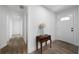 Bright foyer featuring wood floors, a white front door, and a decorative table at 3904 Bakers Ferry Sw Rd, Atlanta, GA 30331