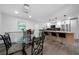 Open concept kitchen features a dining area, island with bar stools, and modern appliances at 3904 Bakers Ferry Sw Rd, Atlanta, GA 30331