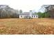Exterior view of the back of the home and yard with deck and patio area at 7460 Highway 101 N, Rockmart, GA 30153