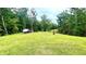 Spacious backyard with a cleared area and mature trees beyond at 7460 Highway 101 N, Rockmart, GA 30153