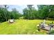 Expansive backyard with mature trees, deck, chicken coop, and storage shed at 7460 Highway 101 N, Rockmart, GA 30153