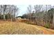 Expansive backyard with trees and a glimpse of the home, offering privacy and space at 7460 Highway 101 N, Rockmart, GA 30153