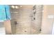 Luxurious tiled shower with glass enclosure, window, and built-in shelving at 7460 Highway 101 N, Rockmart, GA 30153