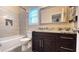 Modern bathroom with a combo tub and shower, sleek vanity with granite counters, and large decorative mirror at 7460 Highway 101 N, Rockmart, GA 30153