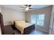 Cozy bedroom with a ceiling fan, natural light from the window, and comfortable furnishings for relaxation at 7460 Highway 101 N, Rockmart, GA 30153