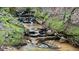 Beautiful creek featuring rocky banks, moss accents, and clear flowing water at 7460 Highway 101 N, Rockmart, GA 30153