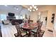 Open-concept dining room with modern chandelier, table with seating, and views into the living room at 7460 Highway 101 N, Rockmart, GA 30153