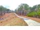 Gravel driveway leads to a wooded property with a newly fenced perimeter at 7460 Highway 101 N, Rockmart, GA 30153
