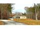 Home exterior with a carport, well-manicured lawn and an adjacent storage building surrounded by trees at 7460 Highway 101 N, Rockmart, GA 30153