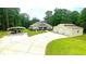 Charming exterior featuring a well-manicured lawn, covered parking, and a detached two-car garage at 7460 Highway 101 N, Rockmart, GA 30153