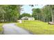 Exterior view of the home with an extra garage, carport and long driveway at 7460 Highway 101 N, Rockmart, GA 30153