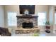 Stone fireplace with a wooden mantle and mounted TV in the spacious living room at 7460 Highway 101 N, Rockmart, GA 30153