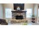 A striking stone fireplace anchors the living room, framed by windows and a large-screen television at 7460 Highway 101 N, Rockmart, GA 30153