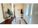Inviting foyer with a decorative mirror, console table, coat rack, and a glass front door at 7460 Highway 101 N, Rockmart, GA 30153