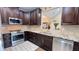 A modern kitchen offers granite counters, stainless appliances, and dark wood cabinets at 7460 Highway 101 N, Rockmart, GA 30153