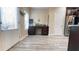Kitchenette with granite countertops, modern cabinetry, stainless steel refrigerator, and gray wood flooring at 7460 Highway 101 N, Rockmart, GA 30153