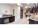 Open kitchen featuring dark cabinetry, granite countertops, stainless appliances and a built-in desk at 7460 Highway 101 N, Rockmart, GA 30153