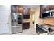 Gourmet kitchen featuring stainless steel appliances, wine rack, granite countertops, and dark wood cabinets at 7460 Highway 101 N, Rockmart, GA 30153