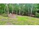 View of a wooded lot with a small, simple storage building in the background at 7460 Highway 101 N, Rockmart, GA 30153