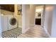Convenient laundry room with modern washer and dryer units and stylish flooring, adjacent to a bathroom at 7460 Highway 101 N, Rockmart, GA 30153