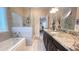 Spacious bathroom featuring double sink vanity, soaking tub, and glass shower at 7460 Highway 101 N, Rockmart, GA 30153