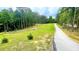 A long driveway leads to a wooded property at 7460 Highway 101 N, Rockmart, GA 30153