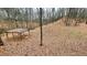 An angled outdoor space covered in fallen leaves featuring a framed shelter with roof at 7460 Highway 101 N, Rockmart, GA 30153