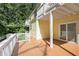 A lovely home featuring a wood deck with white railings and access to the yard and upper level at 1202 Laurel Cliff Se Dr, Smyrna, GA 30082