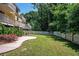 Grassy backyard framed by a white fence and lush trees, offering privacy and a serene outdoor space at 1202 Laurel Cliff Se Dr, Smyrna, GA 30082