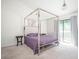 Bright bedroom with modern four poster bed, patterned wallpaper, and access to balcony at 1202 Laurel Cliff Se Dr, Smyrna, GA 30082