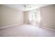 Spacious bedroom with large window and neutral-toned walls and carpet at 1202 Laurel Cliff Se Dr, Smyrna, GA 30082