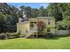 Two-story home with a well-manicured lawn and charming staircase entry nestled amongst mature trees at 1202 Laurel Cliff Se Dr, Smyrna, GA 30082