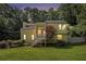 Two-story home with a well-manicured lawn and charming staircase entry nestled amongst mature trees at 1202 Laurel Cliff Se Dr, Smyrna, GA 30082