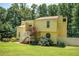 Charming yellow two-story home with well-manicured front lawn at 1202 Laurel Cliff Se Dr, Smyrna, GA 30082