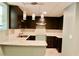 Modern kitchen with dark cabinets, white marble countertop, and stylish pendant lights at 1202 Laurel Cliff Se Dr, Smyrna, GA 30082