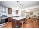 Modern kitchen featuring stainless steel appliances, hardwood floors, and a stylish island with bar seating at 1202 Laurel Cliff Se Dr, Smyrna, GA 30082
