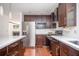 Updated kitchen features stainless steel appliances, light countertops, and rich wood cabinets at 1202 Laurel Cliff Se Dr, Smyrna, GA 30082
