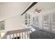 Loft with ceiling fan, carpeted floor, and doors leading to a balcony at 1202 Laurel Cliff Se Dr, Smyrna, GA 30082
