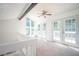 Sunlit loft area features double doors with balcony and multiple windows at 1202 Laurel Cliff Se Dr, Smyrna, GA 30082