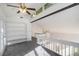Bright loft area with vaulted ceiling, fan, and built-in shelving at 1202 Laurel Cliff Se Dr, Smyrna, GA 30082