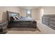 Bedroom features a window, neutral carpet, and a large bed with drawers and a gray finish at 3530 Ridge Hill Pkwy, Douglasville, GA 30135